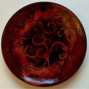 Gorgeous ceramic saucer shaped bowl. Crimson tones with a green back. 4.25”
